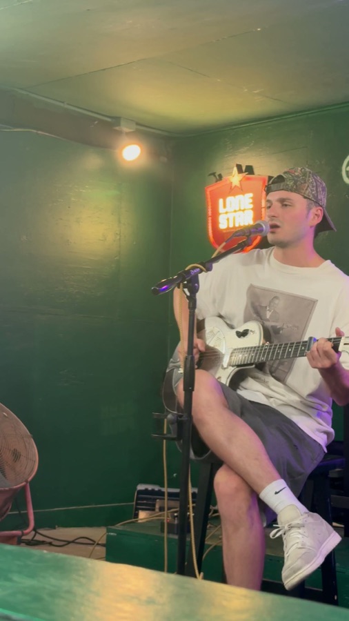 Neck Barham singing into the mic, live